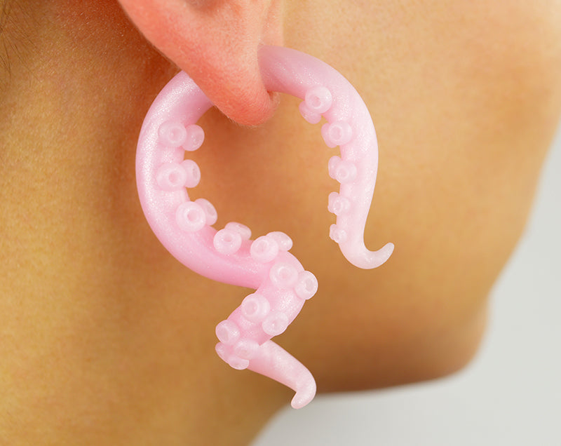 Unique rose quartz earrings by Tania Chernova. Handmade yami kawaii pastel goth pink Sweet Lolita fashion tentacle earrings and tentacle gauges. Octopus tentacle earrings that look like real rose quartz crystal but lightweight and not brittle. Pink rose quartz crystal imitation. Pastel pink goth aesthetic earrings in decora fairy kei fashion style. Pastel decora kei earrings.