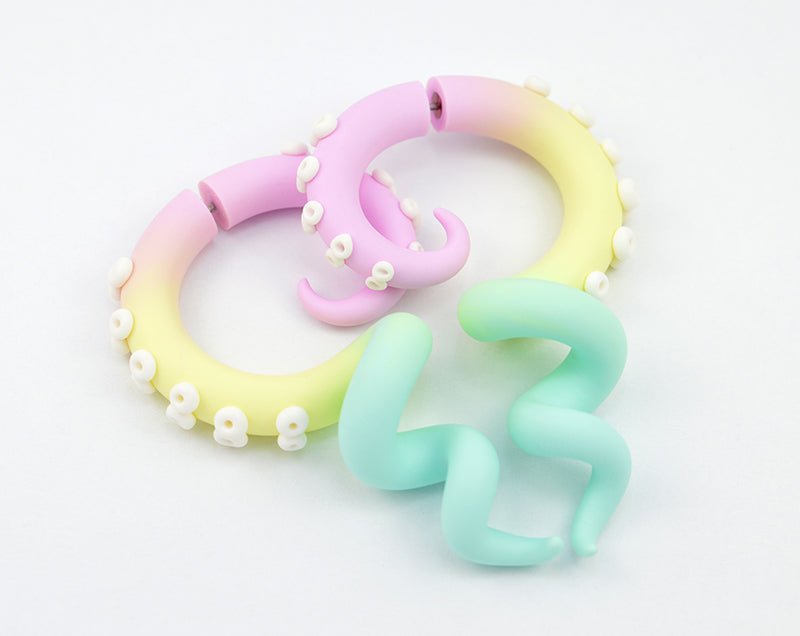 Pastel rainbow aesthetic earrings yami kawaii pastel goth tentacle earrings, rainbow earrings with pastel colors. Light pink, vanilla or light yellow, mint or light green aesthetic tentacle earrings with white suction cups. Kpop fairy kei fake gauge earrings.