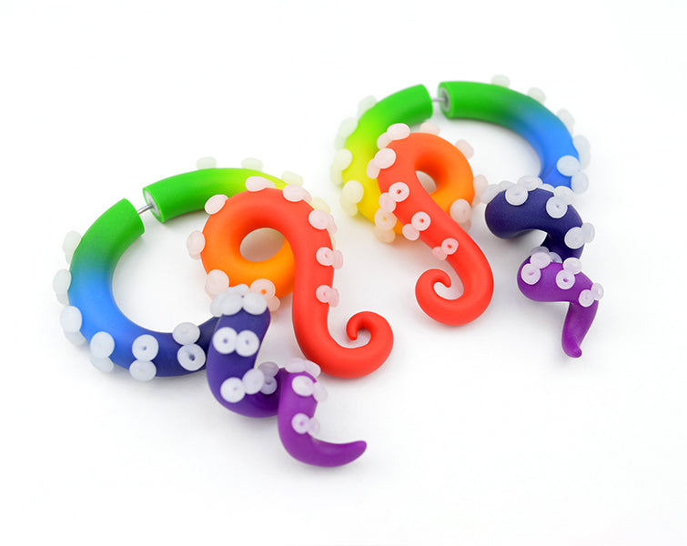 Rainbow earrings by Tania Chernova, octopus tentacle earrings, gay pride earrings and pride gauges 1g 0g 00g 000g. Rainbow fake gauge earrings, red orange yellow green light blue navy blue purple. Pride body jewelry.