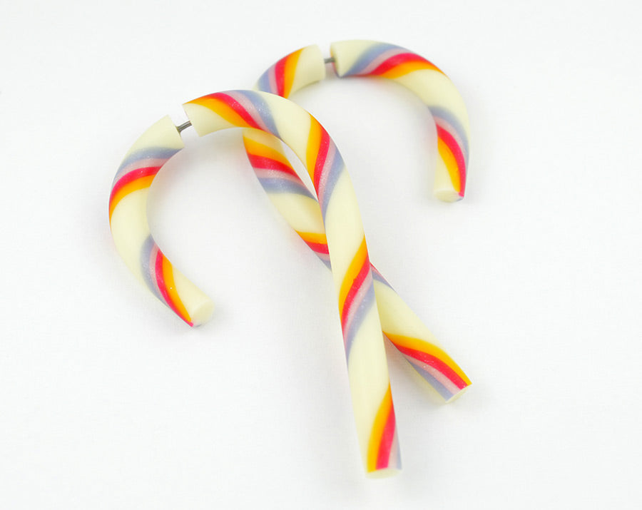 I made these merry christmas earrings in the shape of candy cane with glow in the dark, translucent orange, glitter red, glitter pink and glitter blue polymer clay. I can make both candy cane gauges and fake gauge earrings. Candy cane earrings glows in the dark after held near a light source.