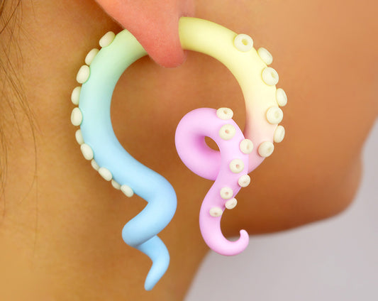 I made these pastel goth octopus tentacle earrings with night glow or glow in the dark suckers. The three tentacle body colors look like pastel rainbow, I used light pink vanilla light yellow and light blue ombre. For these yami kawaii goth gauges I can do both faux gauges and real ear gauges. Kawaii earrings by Tania Chernova, pastel goth earrings. Handmade tentacle gauges, unique body jewelry, taper earrings glow in the dark party supplies octopus gauges good for glow in the dark party.