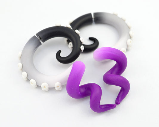 Asexual earrings by Tania Chernova. Ace pride lgbt octopus tentacle earrings tentacle gauges in asexual flag colors - black, grey, white and purple.