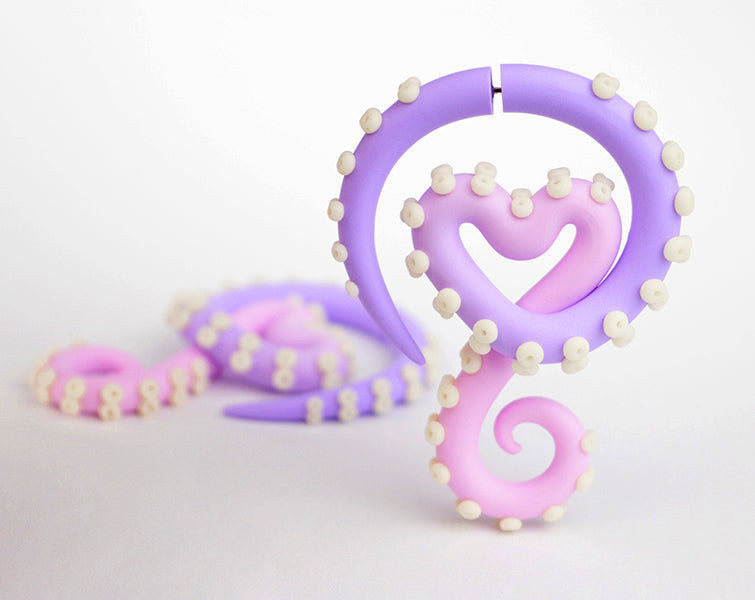 Pastel goth earrings, light pink light purple tentacle earrings fake ear gauges with glow in the dark suction cups. Yami kawaii earrings.