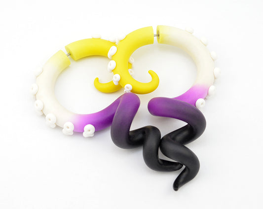 Unique nonbinary earrings by Tania Chernova, LGBT octopus tentacle earrings, nonbinary pride nonbinary jewelry. Non binary earrings, genderqueer earrings. Fake gauge earrings and ear gauges/ear plugs for gauged/stretched earlobes. Non binary day yellow white purple and black octopus earrings for Non-Binary peoples.