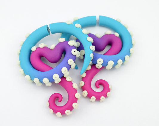 Pink heart earrings with night glow dots, octopus tentacle earrings by Tania Chernova.