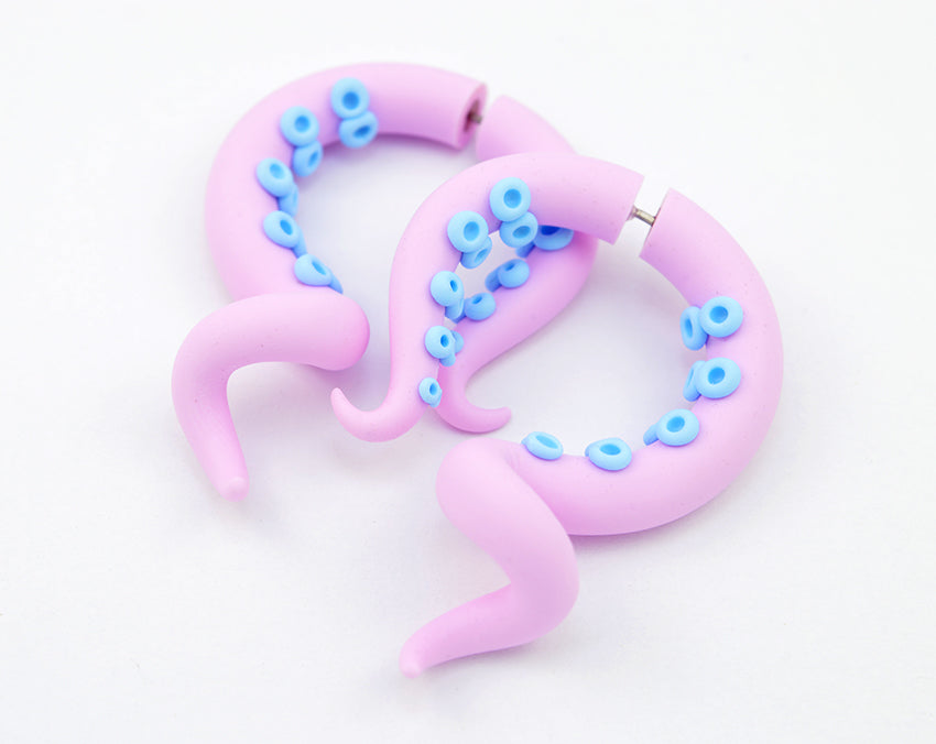 Pastel pink goth aesthetic octopus tentacle earrings by Tania Chernova. Sweet Lolita fashion inspired octopus earrings. Pink kpop yami kawaii fashion fake ear gauges. Stud earrings that look like octopus tentacles. Light pink octopus tentacles with light blue suction cups. Fake tentacle gauges in light pink.