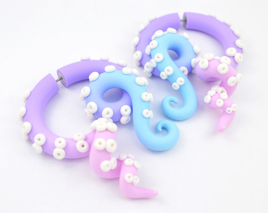 Unique handmade tentacle earrings by Tania Chernova. Pastel goth outfits light blue light purple light pink octopus tentacle earrings with white suction cups yami kawaii fake ear gauges and real ear gauges in 1g 0g 00g 000g. Fairy kei outfit ideas, pastel earrings in cute colors pastel outfit. Kpop Sweet Lolita fashion aesthetic octopus earrings. Fake body jewelry by Tania Chernova.