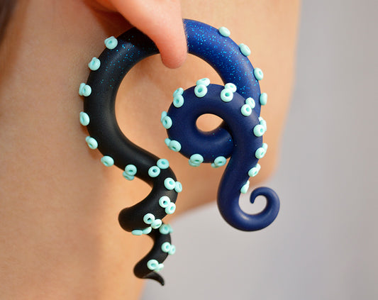 Space inspired octopus tentacle earrings, ear gauges by Tania Chernova. Navy blue glitter blue black earrings with ombre effect and mint suction cups.