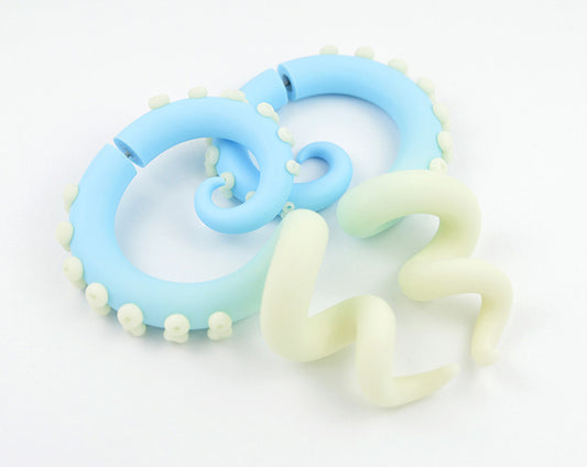 I made these octopus tentacle glow stick earrings with light blue and glow in the dark polymer clay and nightglow dots. Glowing earrings can be crafted as fake ear gauges and as real ear plugs for gauged ears. Just use the menu if you have stretched lobes.